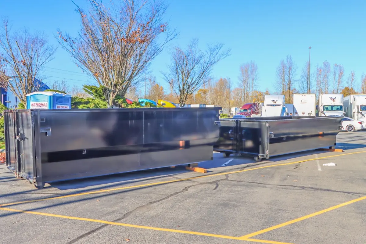 Professional dumpster rental service with roll-off container on residential driveway in Clarkson